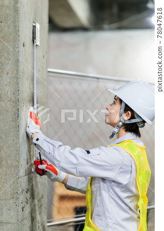 在建築工地使用捲尺的女工 78047618