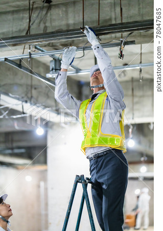 Workers inspecting at the construction site 78047685