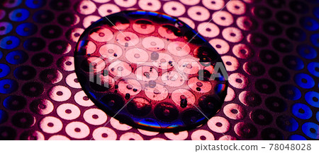 Transparent gel drop on neon blue and pink background. Top view. Virus protection or cosmetics concept. Serum texture close up Transparent gel drop on neon blue and pink background. Top view. Virus protection or cosmetics concept. Serum texture close up 78048028