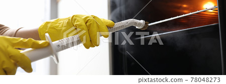 Hands in rubber gloves washing oven with steamer concept 78048273