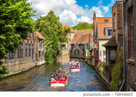 Tourist boat on canal in Bruges 78048605
