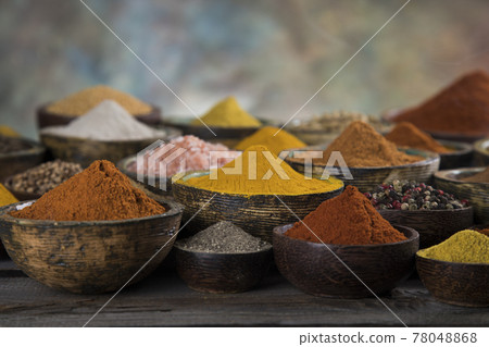 Spices on wooden bowl background Spices on wooden bowl background 78048868