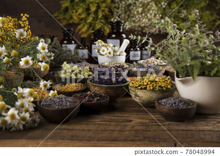 Homeopathy, herbal medicine on wooden table Homeopathy, herbal medicine on wooden table 78048994