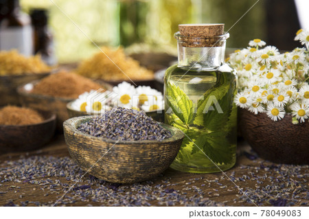 Natural remedy and mortar, healing herbs background Natural remedy and mortar, healing herbs background 78049083