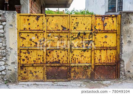 Bullet holes on a gate in Sarajevo 78049104