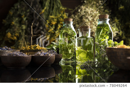 Oil, Natural remedy, healing herbs background 78049264