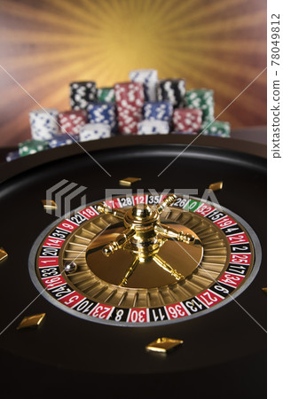 Poker Chips, Roulette wheel in motion, casino background 78049812
