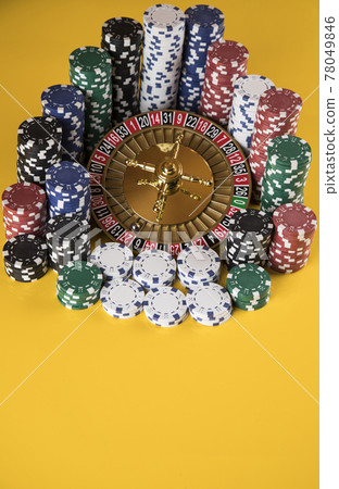 Poker Chips on gaming table, roulette wheel in motion, casino background Poker Chips on gaming table, roulette wheel in motion, casino background 78049846