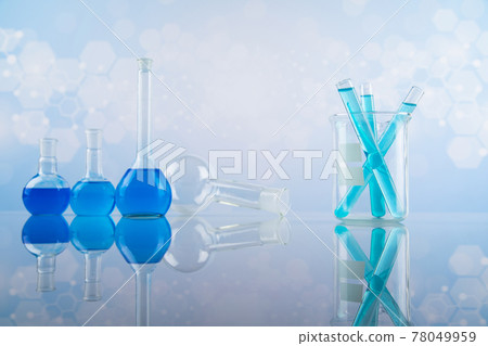 Laboratory beakers, microscope, blue background Laboratory beakers, microscope, blue background 78049959