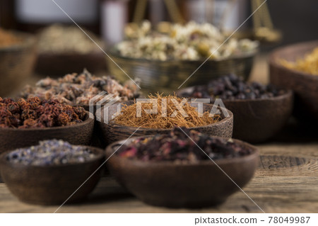 Natural remedy and wooden table background Natural remedy and wooden table background 78049987