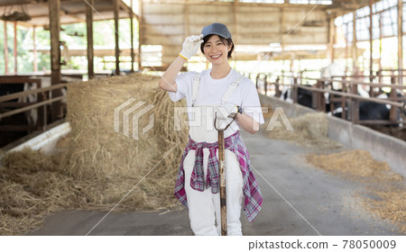 Young dairy farmer working on a ranch Young dairy farmer working on a ranch 78050009