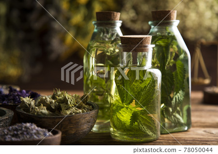Oil, Natural remedy, healing herbs background Oil, Natural remedy, healing herbs background 78050044