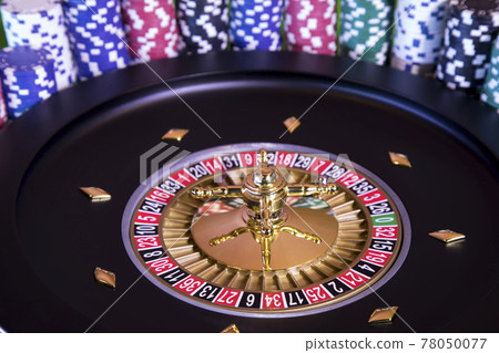 Roulette wheel in motion in a casino background Roulette wheel in motion in a casino background 78050077