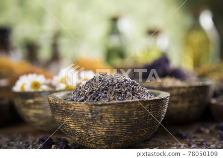 Natural remedy and mortar, healing herbs background Natural remedy and mortar, healing herbs background 78050109