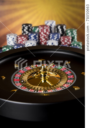 Poker Chips, Roulette wheel in motion, casino background Poker Chips, Roulette wheel in motion, casino background 78050663