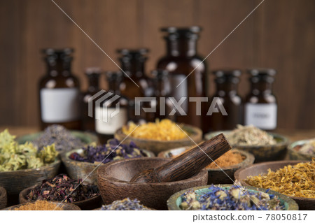 Natural medicine and mortar, healing herbs background Natural medicine and mortar, healing herbs background 78050817