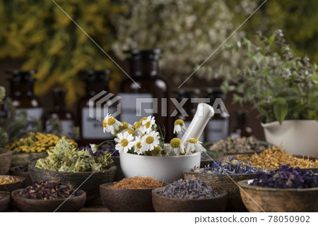 Natural medicine and mortar, healing herbs background Natural medicine and mortar, healing herbs background 78050902