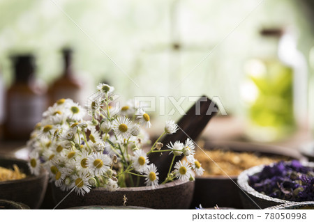 Natural remedy and mortar, healing herbs background Natural remedy and mortar, healing herbs background 78050998