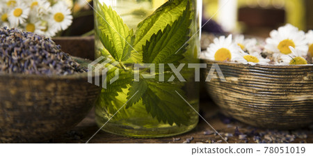 Natural medicine and mortar, healing herbs background Natural medicine and mortar, healing herbs background 78051019