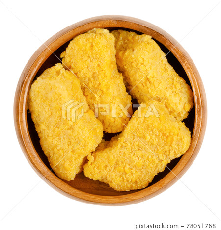 Vegan nuggets, ready to fry, in a wooden bowl. Vegan nuggets, based on soy and wheat protein, in crispy breading, pre-fried and cooked. Close-up, from above, isolated on white background, food photo. 78051768