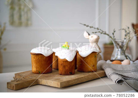 Preparing for Holly holiday. Waist up portrait of happy family showing just baked delicious Easter Preparing for Holly holiday. Waist up portrait of happy family showing just baked delicious Easter 78052286
