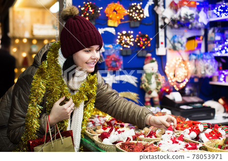 Happy teen girl shopping at festive fair 78053971