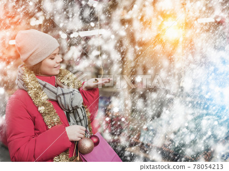Girl shopping Christmas decorations 78054213