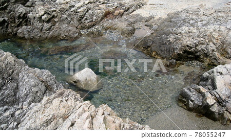 Gray rocky coast, blue sea and blue sky Gray rocky coast, blue sea and blue sky 78055247