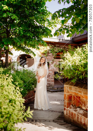 bride on the footpath in the garden. Wedding make-up. bride on the footpath in the garden. Wedding make-up. 78057303
