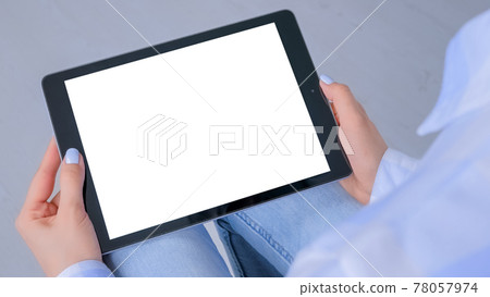 Mockup image - woman looking at tablet computer with white empty display Mockup image - woman looking at tablet computer with white empty display 78057974