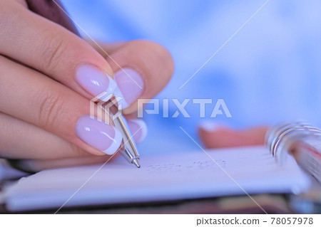 Close up top view - woman writing to do list in vintage notebook organizer 78057978