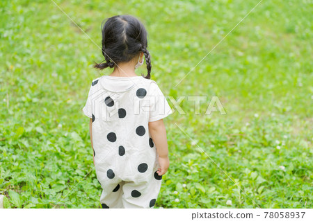 A girl standing on the lawn A girl standing on the lawn 78058937