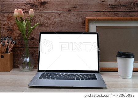 Front view laptop computer, photo frame, pencil holder and coffee cup on white table. Front view laptop computer, photo frame, pencil holder and coffee cup on white table. 78060082