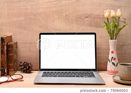 Mock up computer laptop, books, coffee cup, glasses and flowers pot on wooden table. Mock up computer laptop, books, coffee cup, glasses and flowers pot on wooden table. 78060083