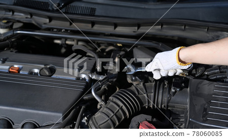 Close up view of mechanic repair a car engine in auto car garage. Close up view of mechanic repair a car engine in auto car garage. 78060085