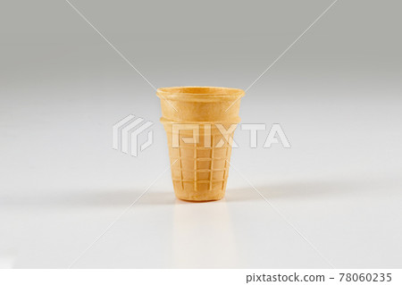 Empty, toasty wafer cup for ice cream isolated on white. Concept of food, treats. Mockup, template for your advertising and design. Close up 78060235