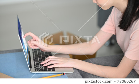 Close-up womanchecking address her computer laptop over comfortable sitting room. Shopping online, SME concept Close-up womanchecking address her computer laptop over comfortable sitting room. Shopping online, SME concept 78060267