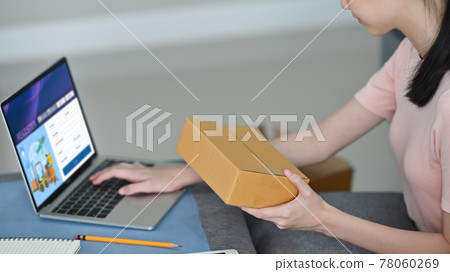 young business owner using a computer sitting at home, Sme concept. young business owner using a computer sitting at home, Sme concept. 78060269