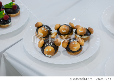 Fresh shortcrust tart cakes with chocolate and sweet mushrooms for sale 78060763