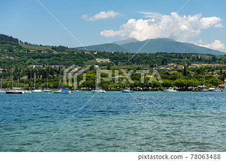 Coast of Lake Garda in front of the small village of Bardolino - Veneto Italy 78063488