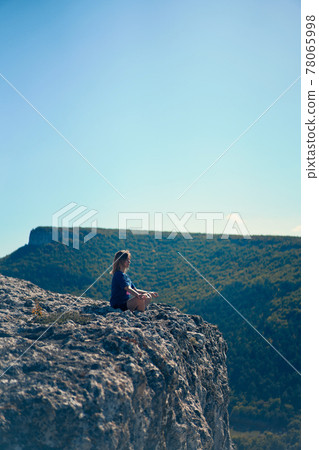 Young woman sitting on a rock and thinking - Stock Photo - Masterfile -  Premium Royalty-Free, Code: 630-01876858