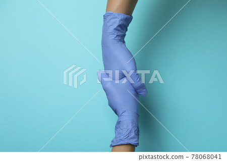 Doctors shake hands in medical gloves on blue background 78068041