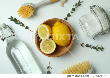 Cleaning concept with eco friendly cleaning tools and lemons on white background Cleaning concept with eco friendly cleaning tools and lemons on white background 78069135