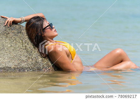Portrait of thai woman posing outdoors at the sea beach Portrait of thai woman posing outdoors at the sea beach 78069217