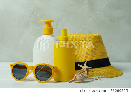 Summer concept with sunscreen on white wooden table Summer concept with sunscreen on white wooden table 78069225