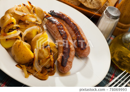 Roasted sausages with potatoes Roasted sausages with potatoes 78069993