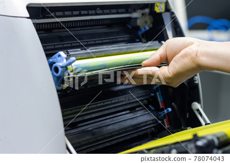 Technicians replacing toner in laser printer concept office supplies repair Technicians replacing toner in laser printer concept office supplies repair 78074043