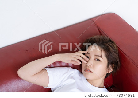 Genderless LGBT woman lying on the sofa 78074681