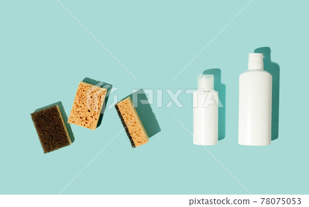 Set of neutral beige clean sponges, bottles with liquid soap or disinfect on blue background. Banner for site, concept for laundry, cleaning service, advertising, spring regular cleaning day Set of neutral beige clean sponges, bottles with liquid soap or disinfect on blue background. Banner for site, concept for laundry, cleaning service, advertising, spring regular cleaning day 78075053