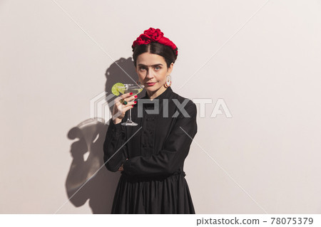 Portrait of young woman in the image of a famous artist, person isolated on white wall background with shadow. Comparison of eras concept. Portrait of young woman in the image of a famous artist, person isolated on white wall background with shadow. Comparison of eras concept. 78075379